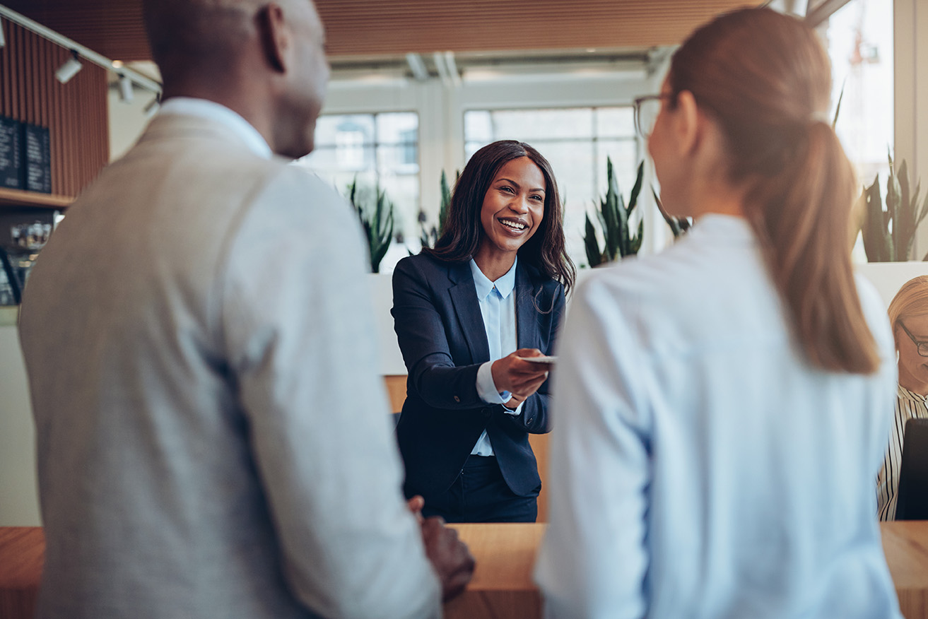 Concierge professional assisting guests in a modern workplace hospitality space